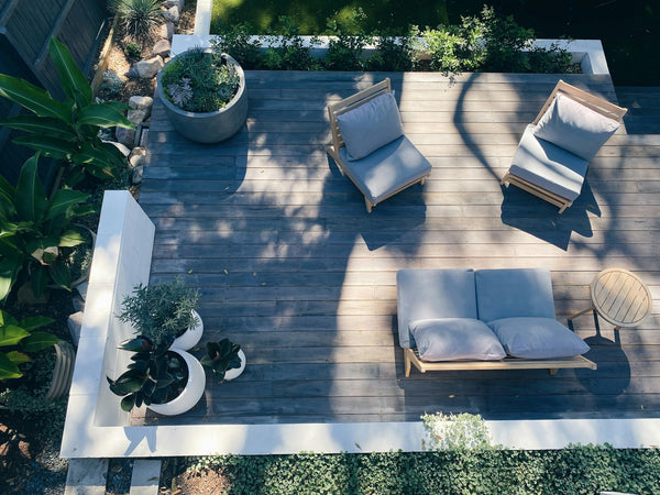 Aerial view of a wooden deck with outdoor furniture and potted plants